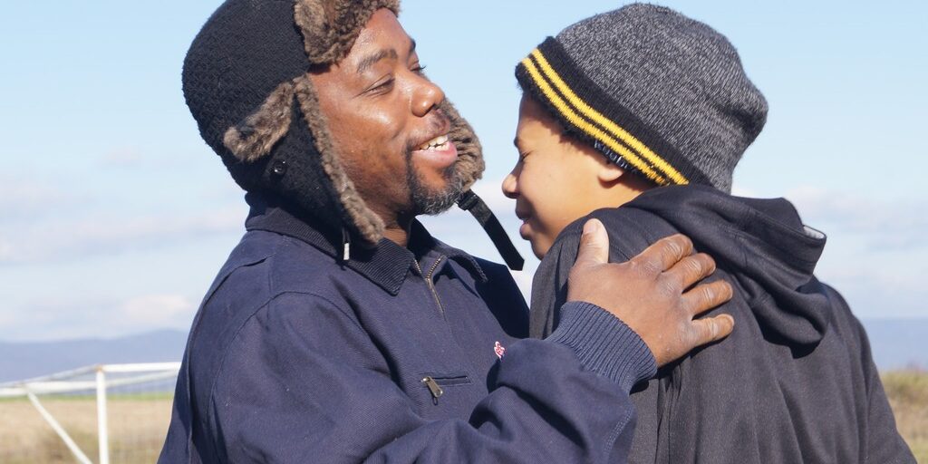 Father and son hug outside