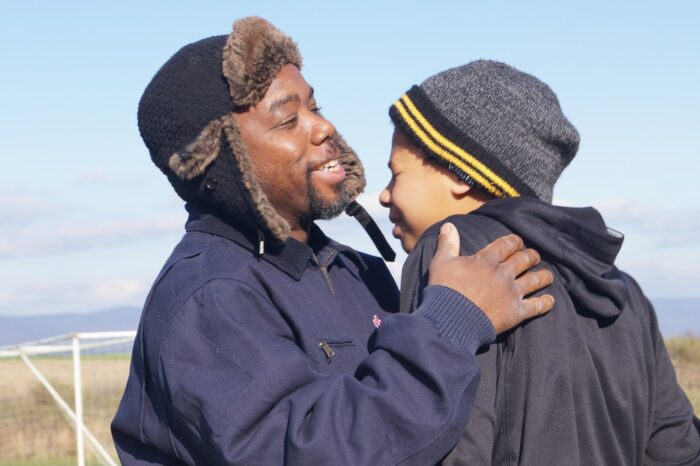 Father and son hug outside