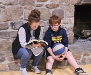 A mom leads her son in devotions at our Christian retreat weekend