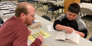 Bible Adventure student and Listener reading Bible